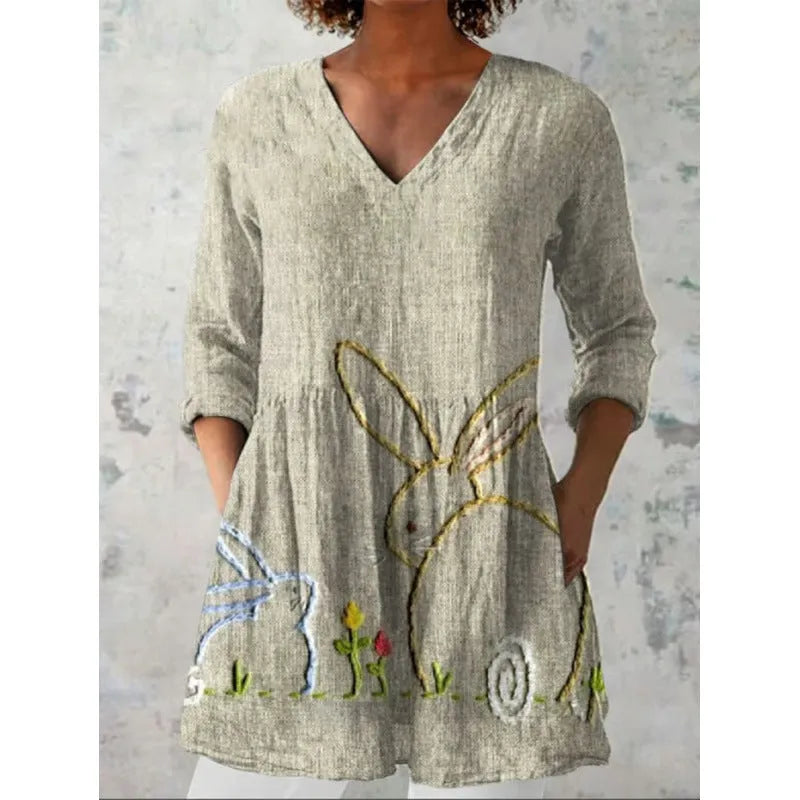 Women's printed wave pattern loose dress with wide waist and three-quarter length sleeves on a hanger.