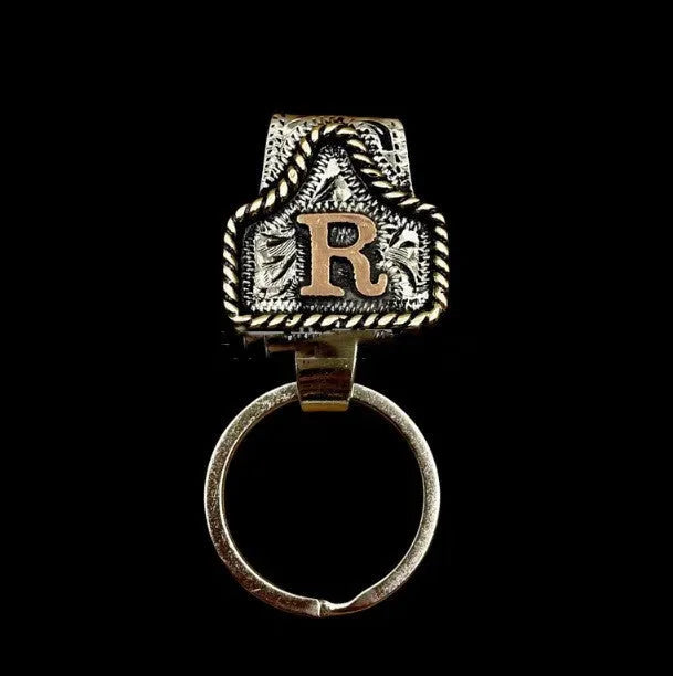 Handmade metal cow tag belt key holder keychain on a key ring, showing the metal loop and tag design.