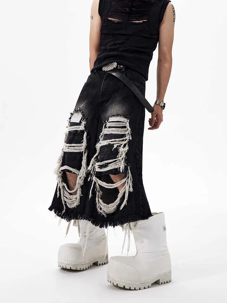 Black wide leg cropped jeans with mid-high waist and ripped patch detail on micro-elastic cotton denim