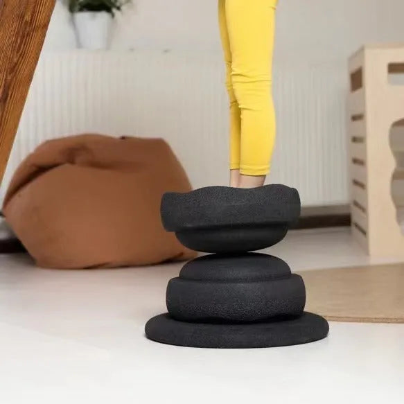 Children's plastic surf-shaped balance board in mixed wood colour and solid black option.