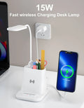 Modern desk lamp with wireless charging surface and integrated pen holder storage compartment