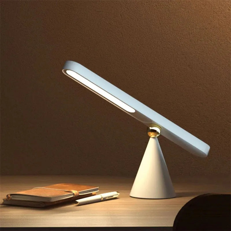 Geometric wireless table lamp with magnetic base in white colour showing touch controls