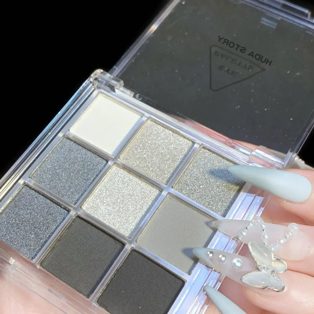 Smoked case nine colour eye shadow palette showing white, silver, black, and iron grey shades