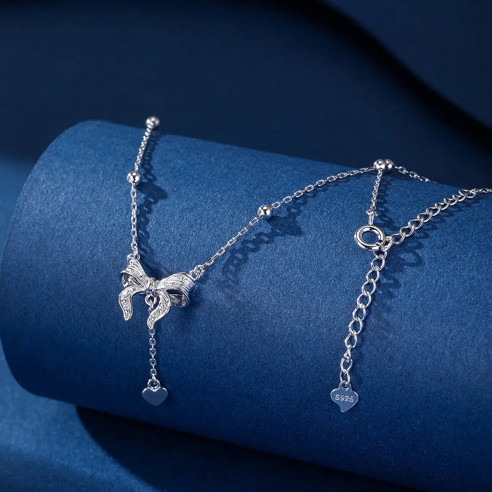 S925 silver butterfly heart necklace on adjustable O-ring chain showing heart pendant with bow and butterfly details
