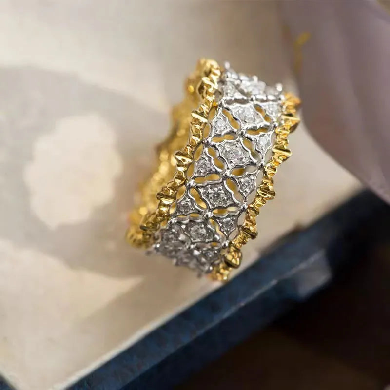 Geometric two-tone gold zircon ring on a copper band, shown in a side view.