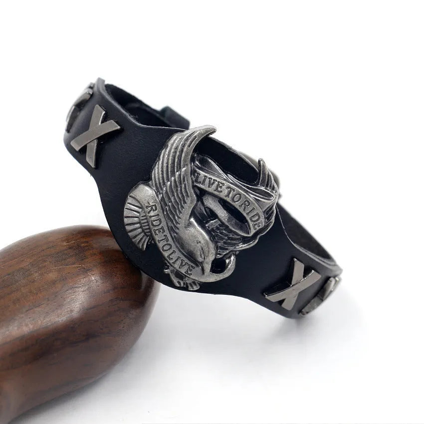 Black geometric leather bracelet with a large alloy eagle watch clasp closure.