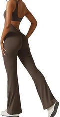 Woman wearing a sleeveless army green flare jumpsuit for yoga, showcasing the fashionable waist and trouser length.
