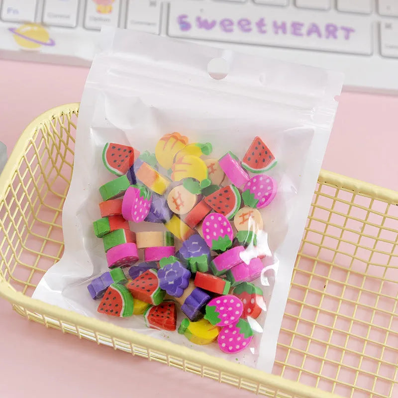 Assortment of 50 colourful cartoon mini erasers including fruits, animals, and themed shapes on a white background.