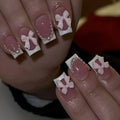 Set of short white French style press-on nail stickers with cute bow and tulip designs.