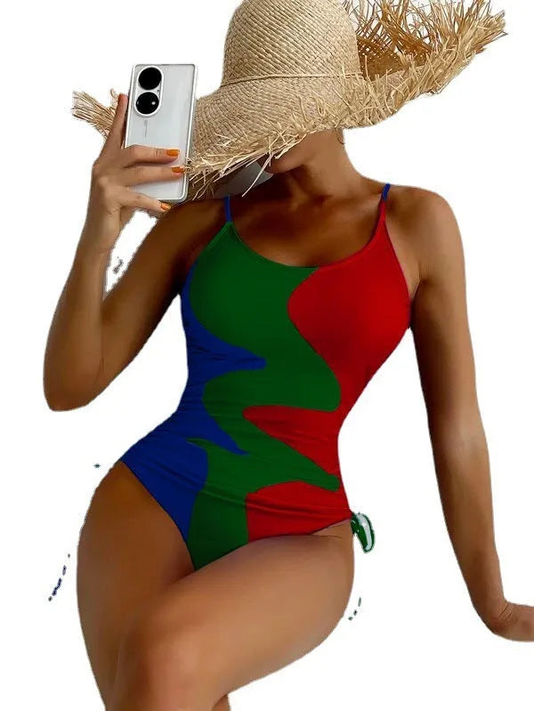 Women's sleeveless backless one-piece swimsuit in a striped pattern, shown in blue.