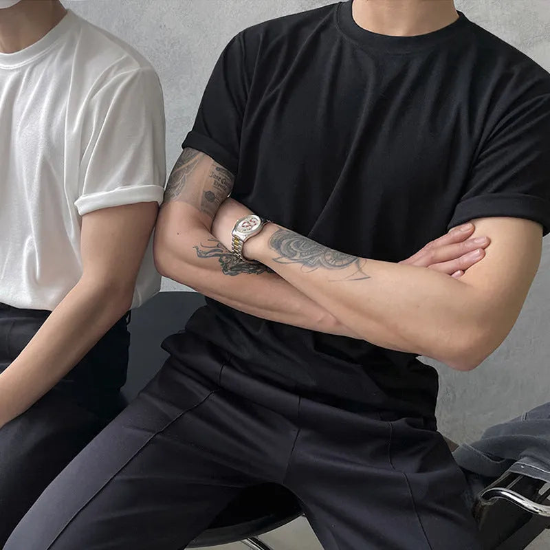 A man's slim-fit cotton T-shirt in solid white, showing the regular half-length sleeves and round neck.