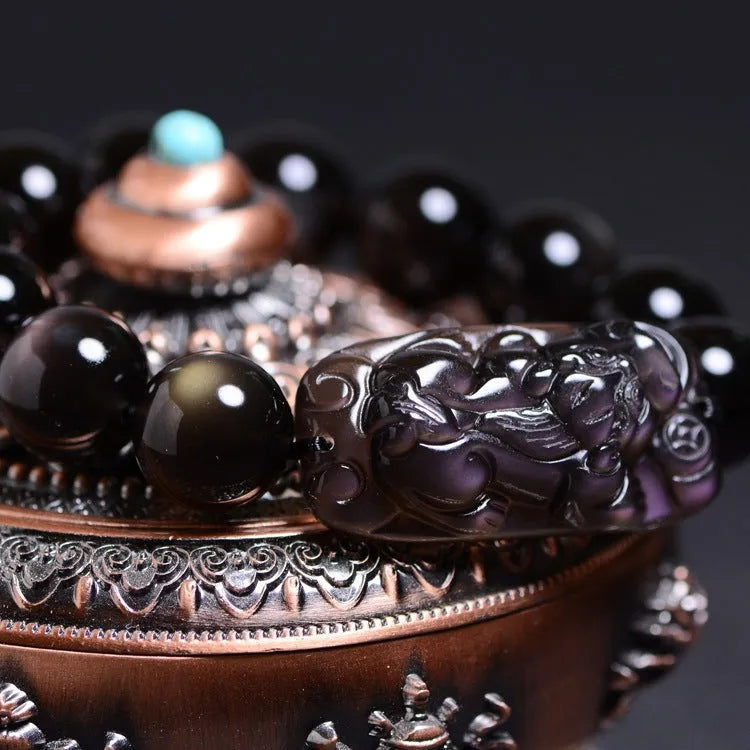 A geometric polished crystal bracelet featuring a Pi Xiu charm on a beaded strand.