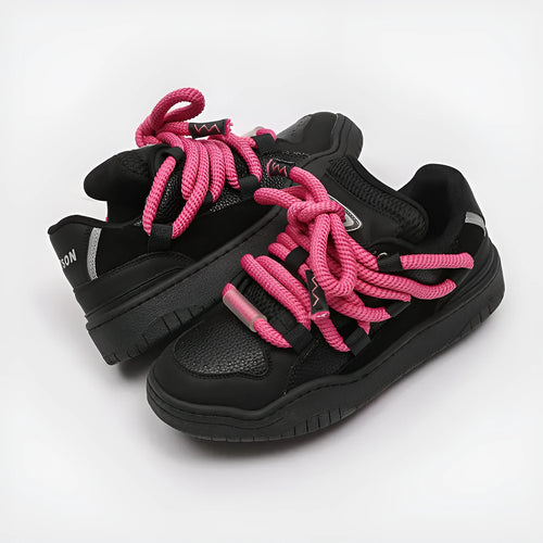 Pair of thick-soled casual lace-up shoes in a solid colour on a white background.