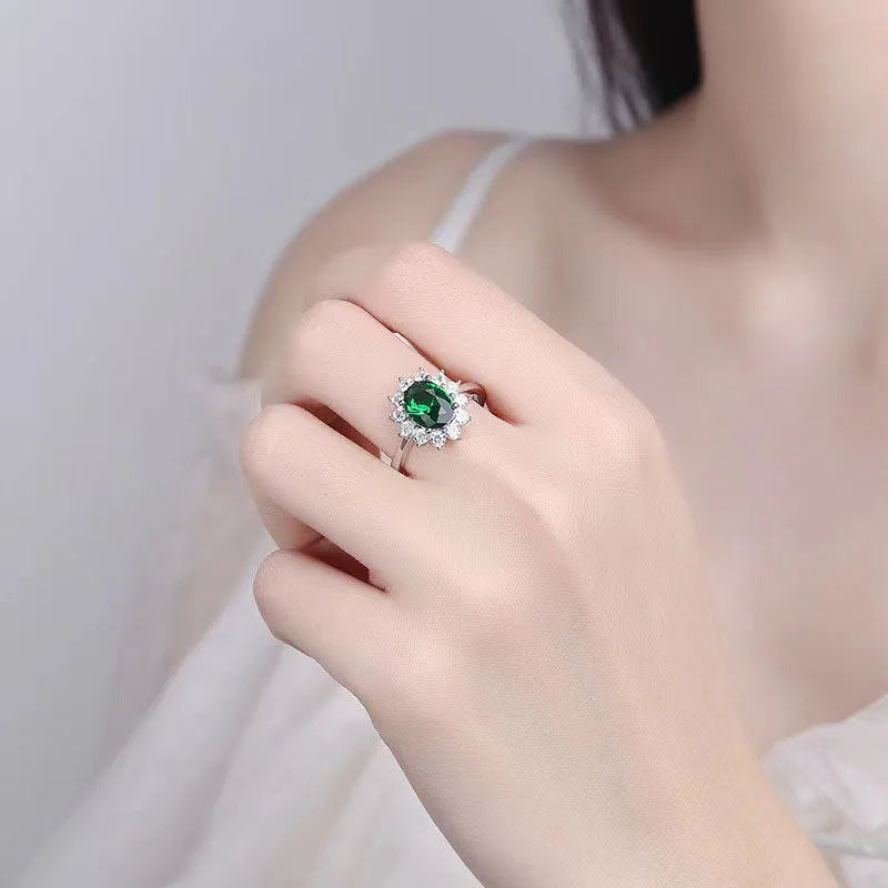 Women's copper flower ring with moissanite centre, shown in green, sapphire blue, and pomegranate red colour options.