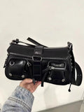 Black women's shoulder messenger bag with adjustable strap showing zippered change compartment interior