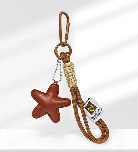 Handmade brown polymer clay soda bread charm on a brown strap, showing cartoon bread design details.