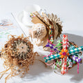 Parrot chewing toy with colourful plastic components and metal hanging chain for cage attachment