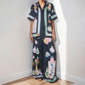 Black women's casual set with cartoon print cardigan top and matching trousers