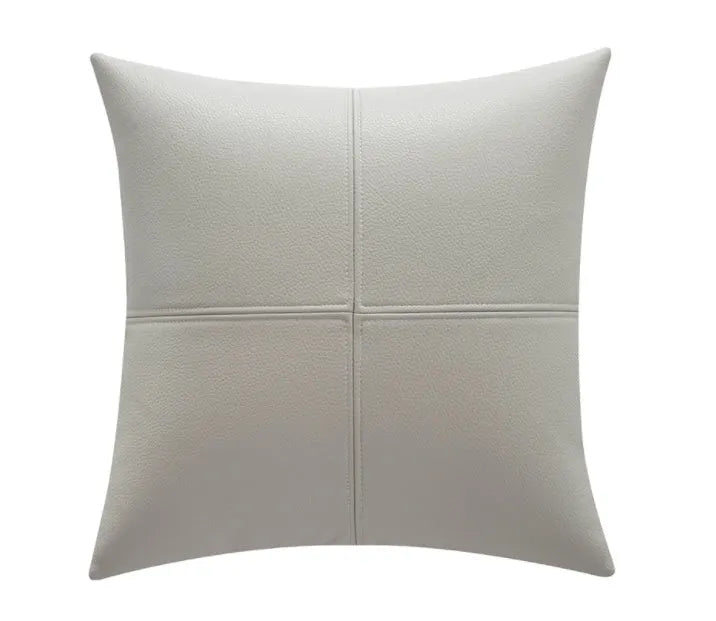 Soft cowhide leather pillow cover in a solid colour, shown in a Nordic-style room setting.