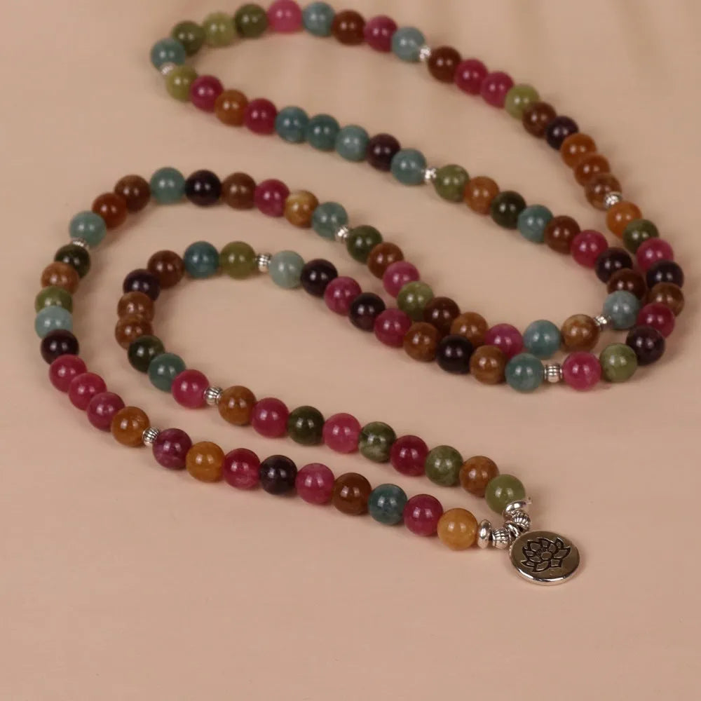 Multi-layer bracelet with 108 beads, a lotus charm, in Tourmaline-coloured alloy.