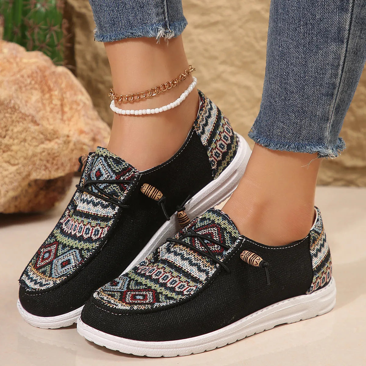 Women's black slip-on flat shoes with round toe and rubber sole on a plain background