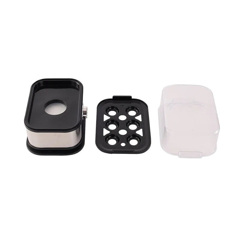 Black portable stainless steel mini egg boiler for travel with multiple power plugs.