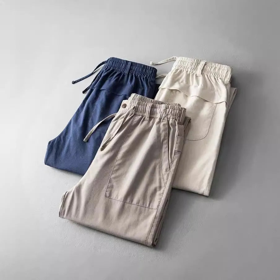 Men's casual linen trousers in a solid colour, shown in a mid-waist, full-length trouser style.