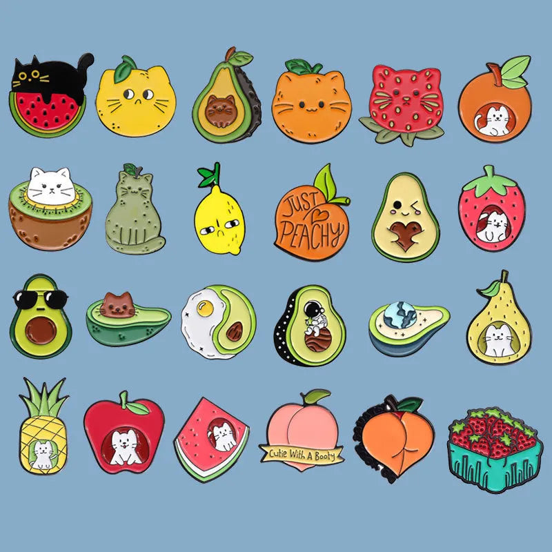 Colourful cartoon fruit design metal brooch pin on a fabric background.
