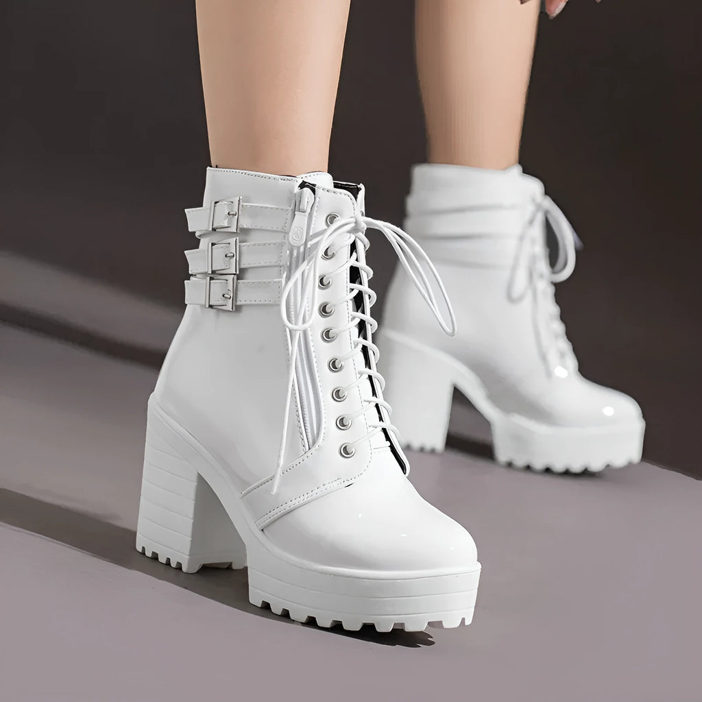 Women's black ankle boots with thick heel, round toe, and front lace-up on a waterproof platform sole.