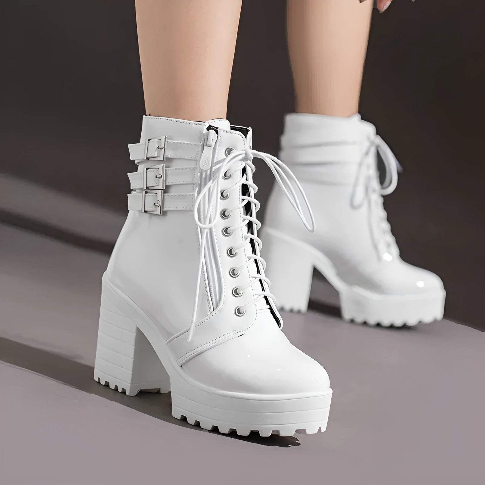 Women's black ankle boots with thick heel, round toe, and front lace-up on a waterproof platform sole.