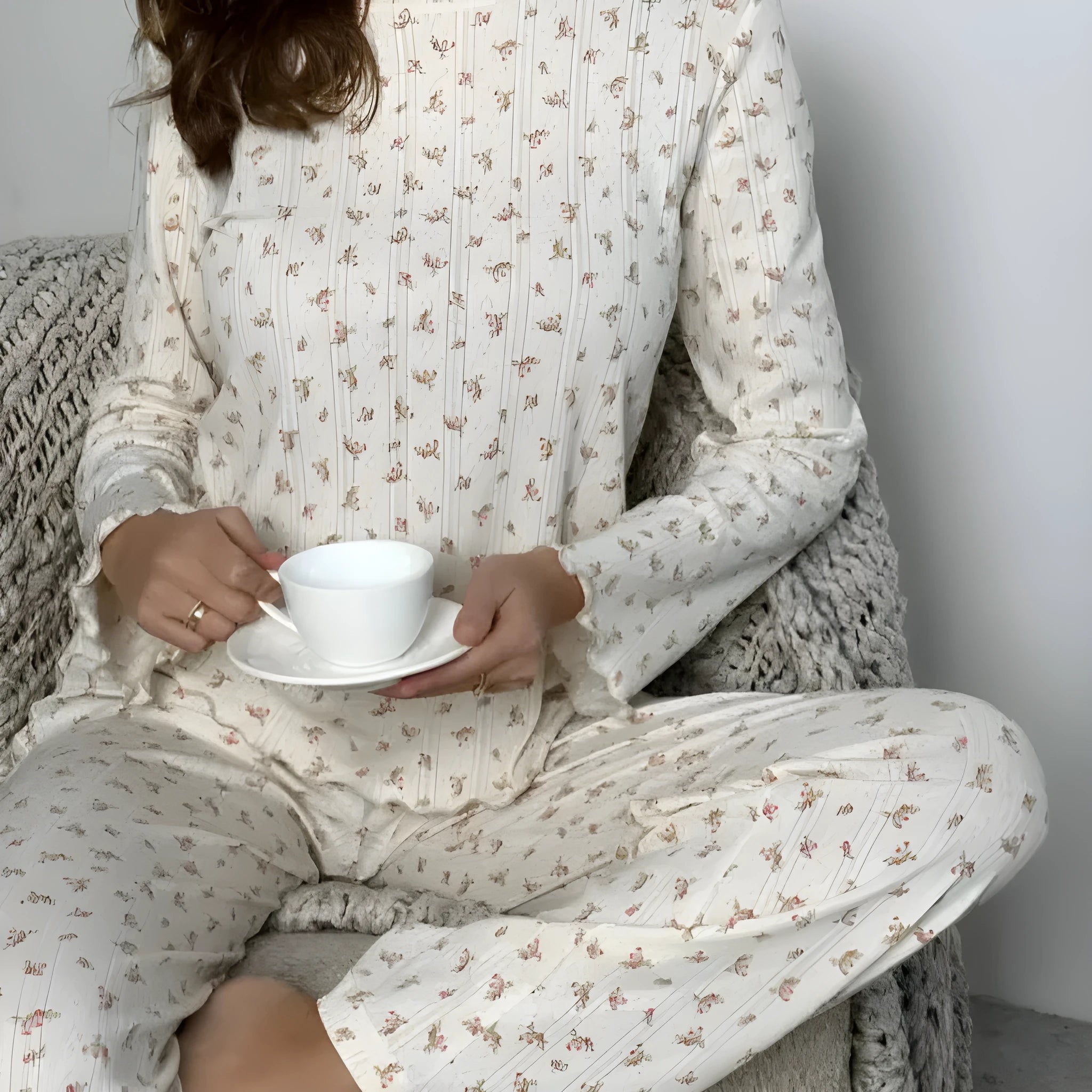 White floral print women's bell sleeve top and wide leg trousers suit on hanger