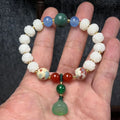 Carved pumpkin lotus bodhi root bracelet with white jade segments and golden silk jade treasures