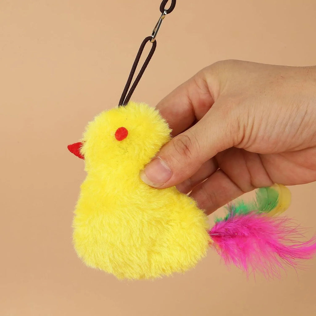 Gray and yellow hanging interactive cat toy with treat dispenser extended on elastic rope