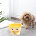 Green robot-shaped elevated cat bowl with tilted design and detachable inner component