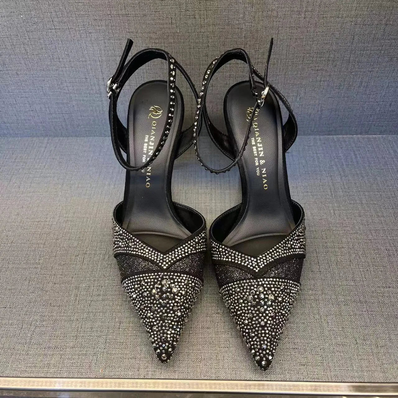 Women's silver and black hollow high heels with red sole and pointed toe design
