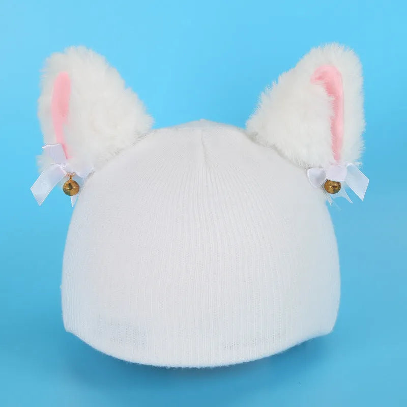 Plush fabric ski helmet decoration with cartoon design on a black ski helmet.