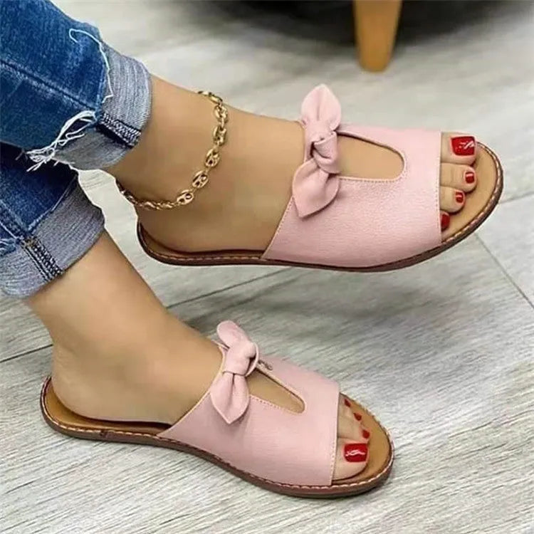 Ladies sandals with bow detail and fish mouth design in black, pink and gold colours