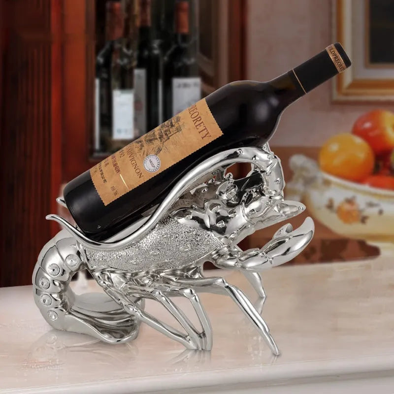 Lobster-shaped wine rack theme ornament in rose gold or silver resin and plastic finish on a shelf.