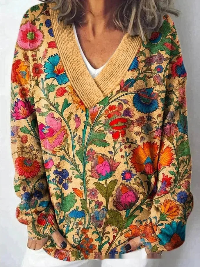 Women's white floral print V-neck sweatshirt with 3D pattern and long sleeves on a hanger.