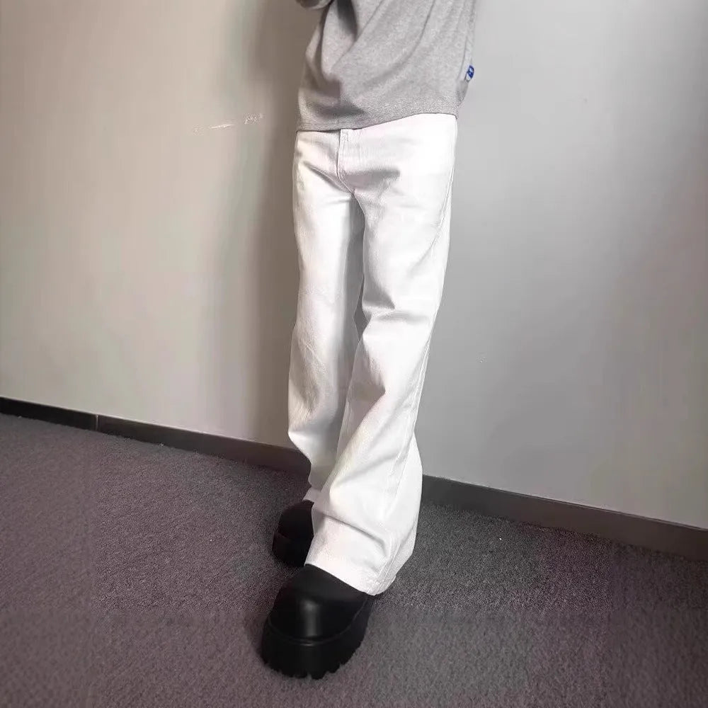A pair of men's white wide-leg straight jeans with a mid-rise waist and zipper fly on a plain background.
