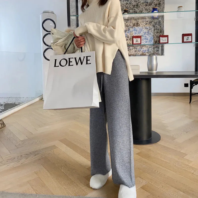 Women's high waist wide-leg knit trousers in cream white colour, laid flat to show straight-leg cut.