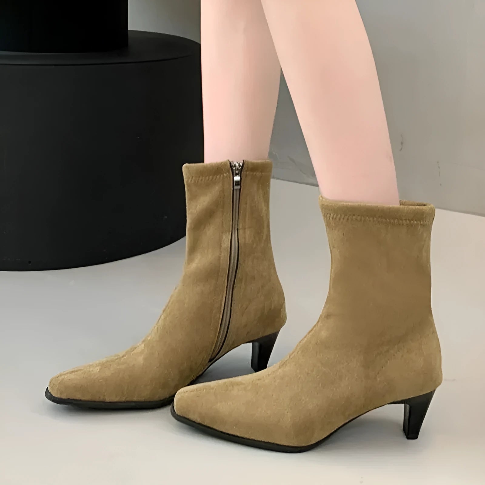 Brown square toe mid calf boots with a kitten heel and side zipper on a white background.