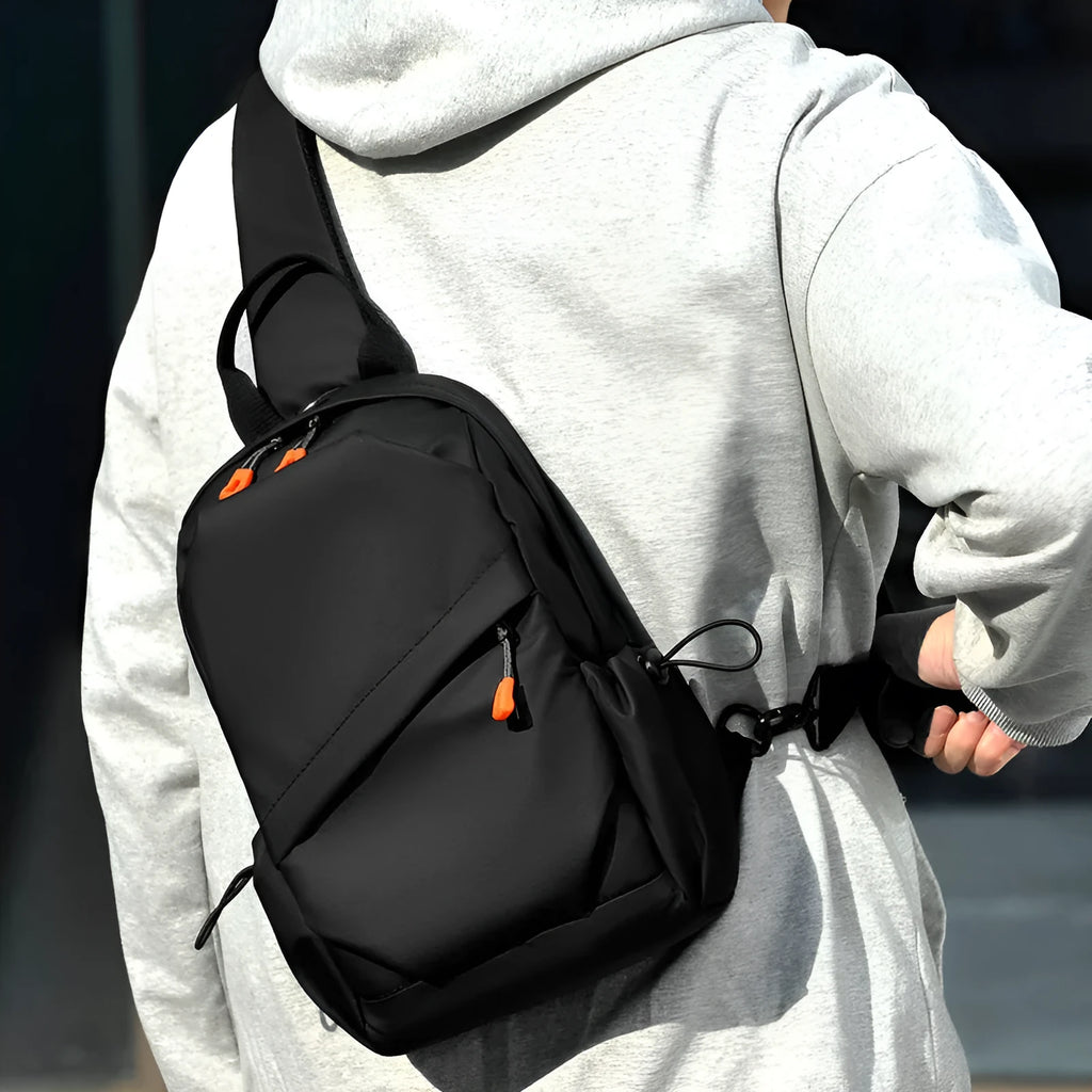 Men's black casual crossbody bag made from waterproof polyester with an adjustable shoulder strap.