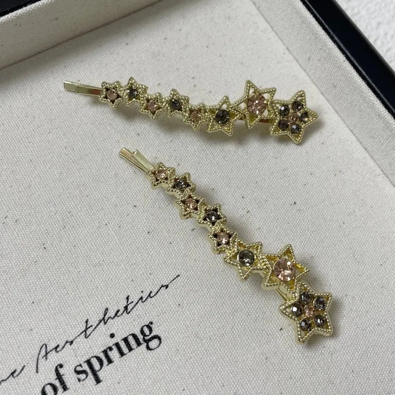 Gold hair barrette clip with rhinestone star detail on side