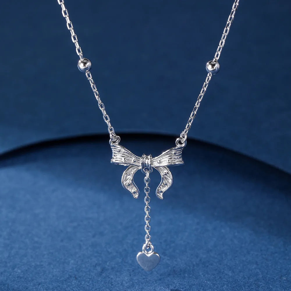S925 silver butterfly heart necklace on adjustable O-ring chain showing heart pendant with bow and butterfly details