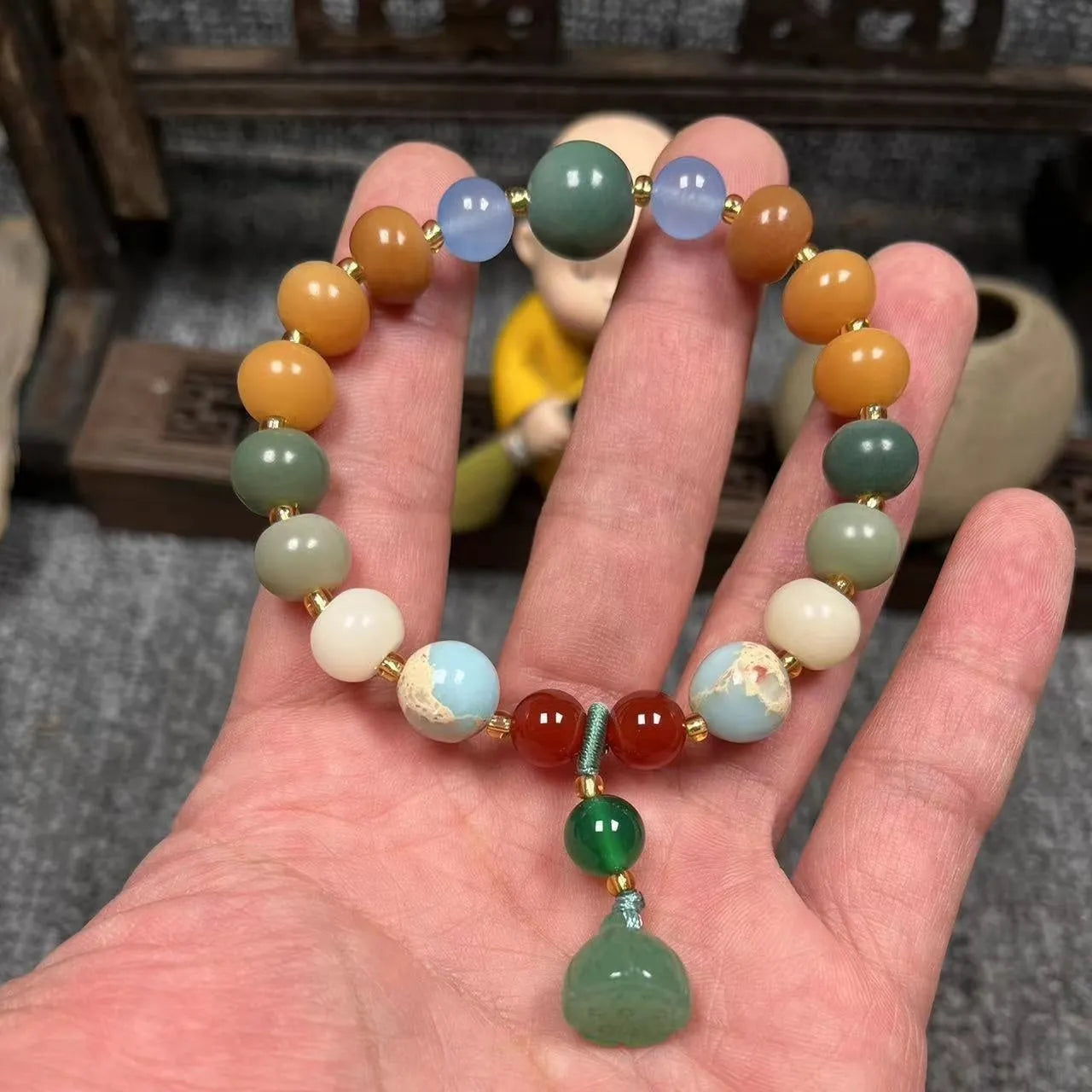 Carved pumpkin lotus bodhi root bracelet with white jade segments and golden silk jade treasures