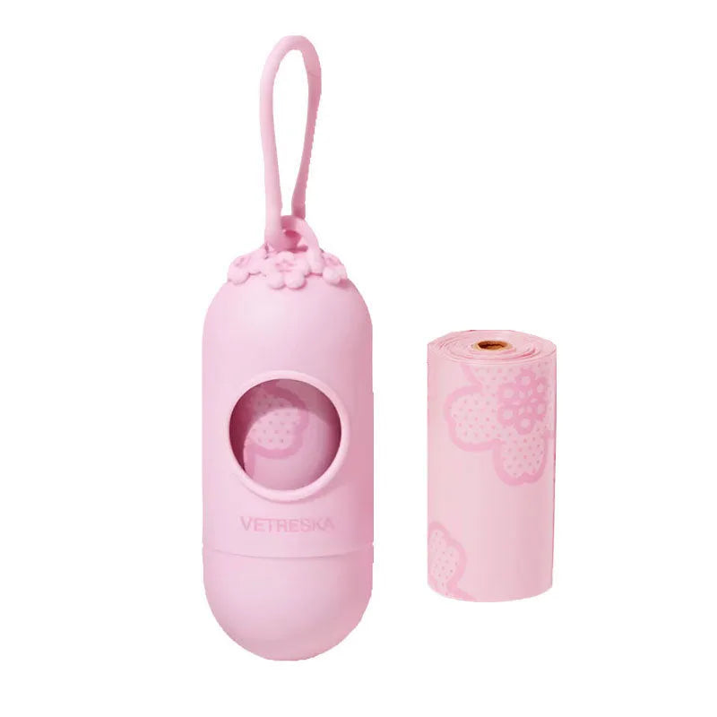 Portable dog poo bag dispenser capsule with strawberry design and a roll of scented biodegradable bags.