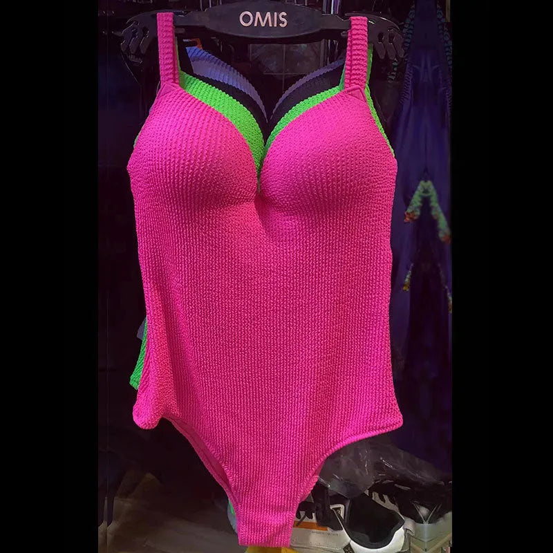 A women's sleeveless one-piece swimsuit on a hanger, shown in black, with other colour options available.