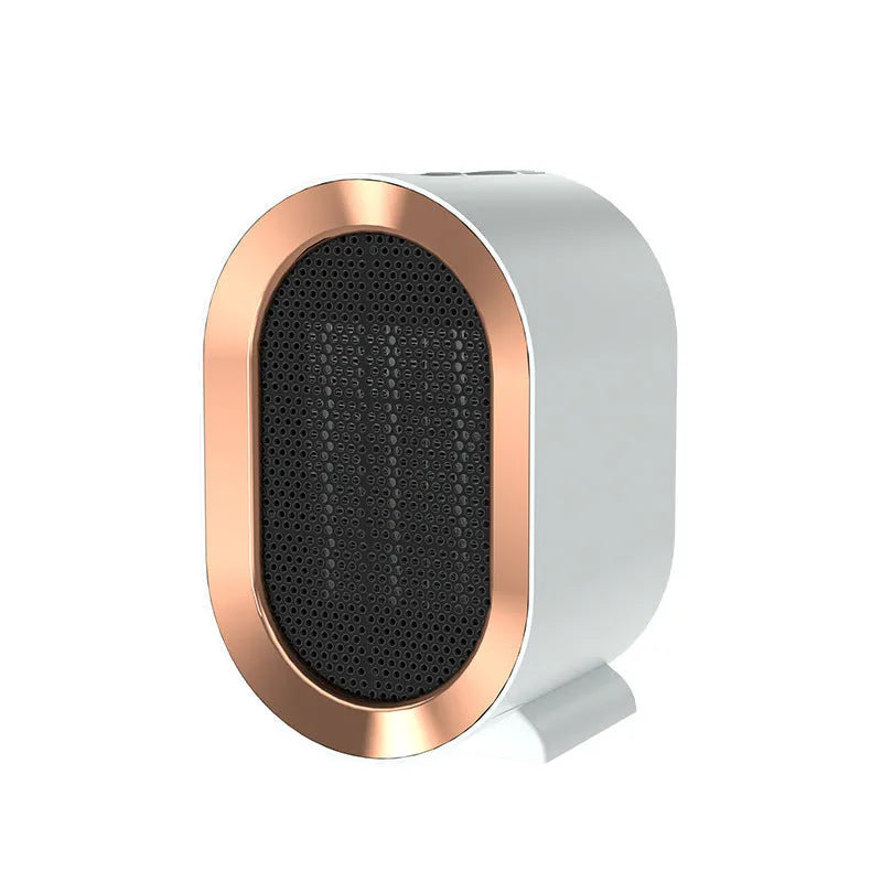 Compact black desktop electric ceramic fan heater with mechanical controls on a wooden desk