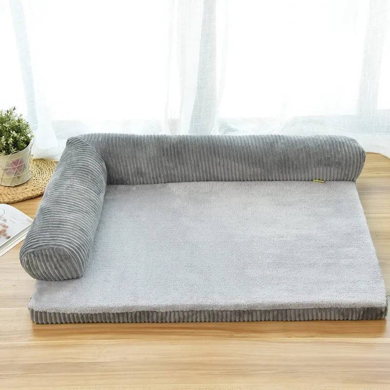 Corduroy dog bed sofa with bolster sides and non-slip base in a neutral colour.